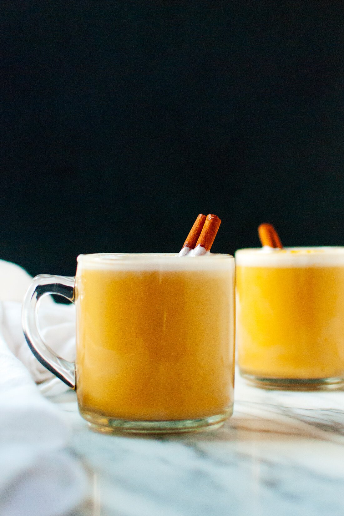 Homemade pumpkin chai lattes made with real pumpkin, almond milk, maple syrup and spicesโrich and creamy, naturally sweetened and only 90 calories!