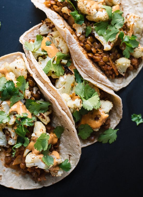 Roasted cauliflower, seasoned lentils and creamy chipotle sauce combine to create an unexpectedly delicious taco! - cookieandkate.com